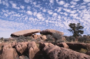 a large rock formation in the middle of a field