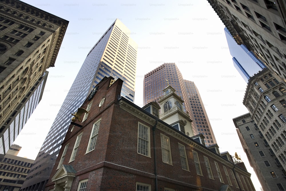 a tall brick building surrounded by other tall buildings