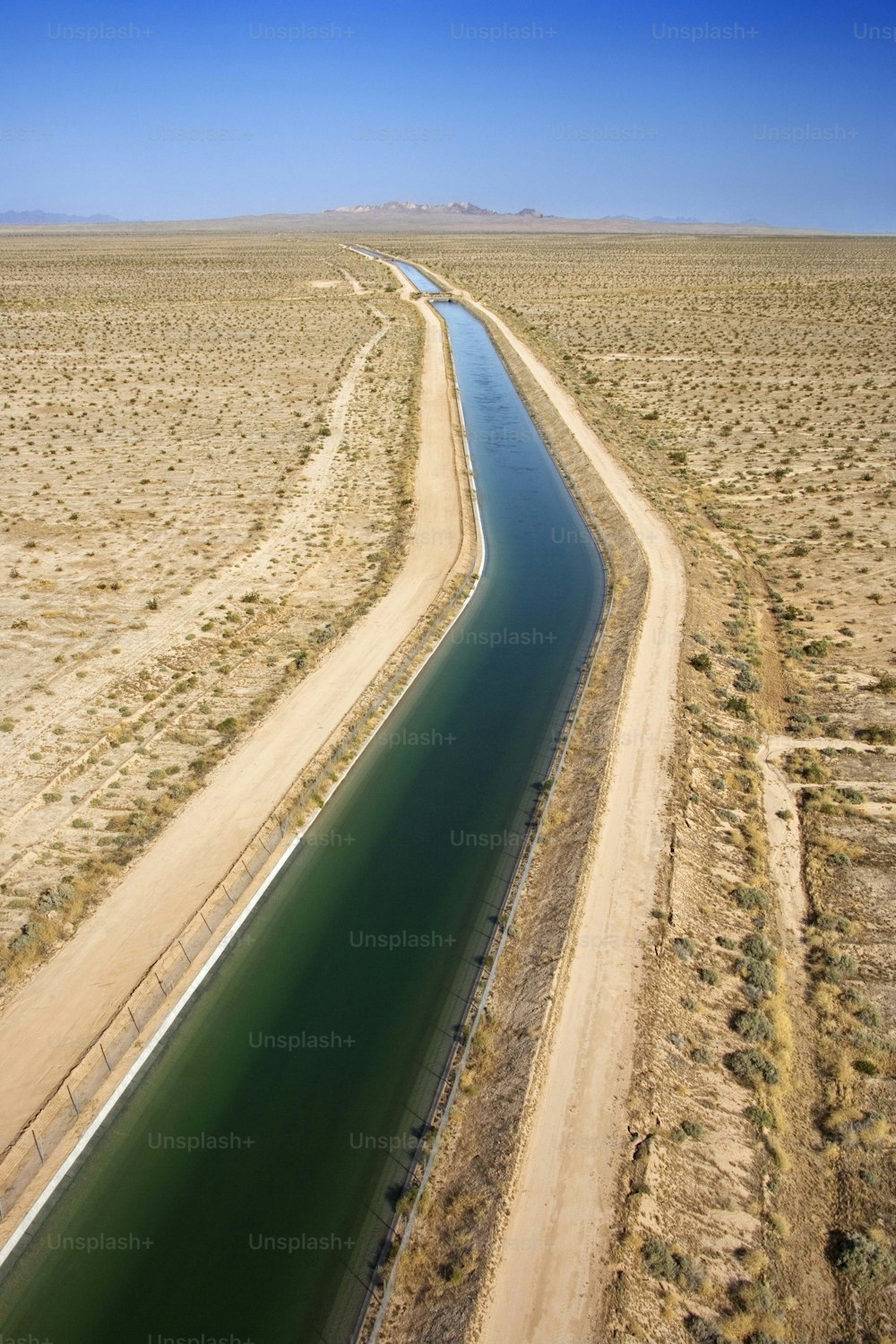 an aerial view of a river running through the desert