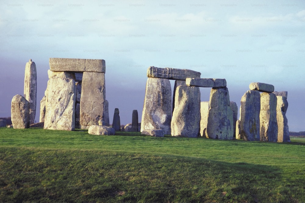 a group of stonehenges in a grassy field