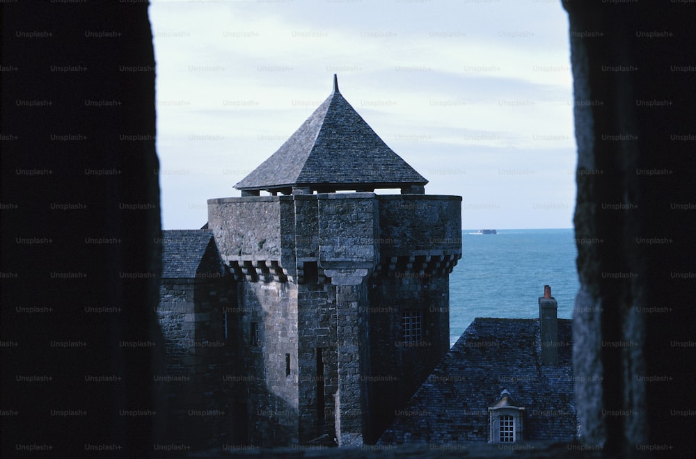 a view of the ocean from a window in a castle