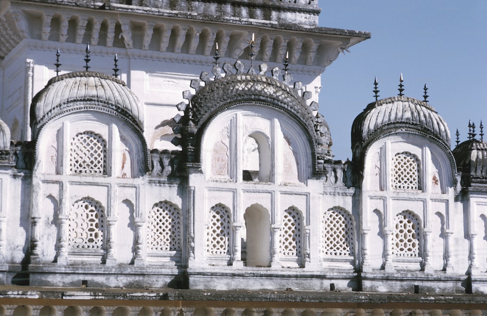 a large white building with a clock on it's side