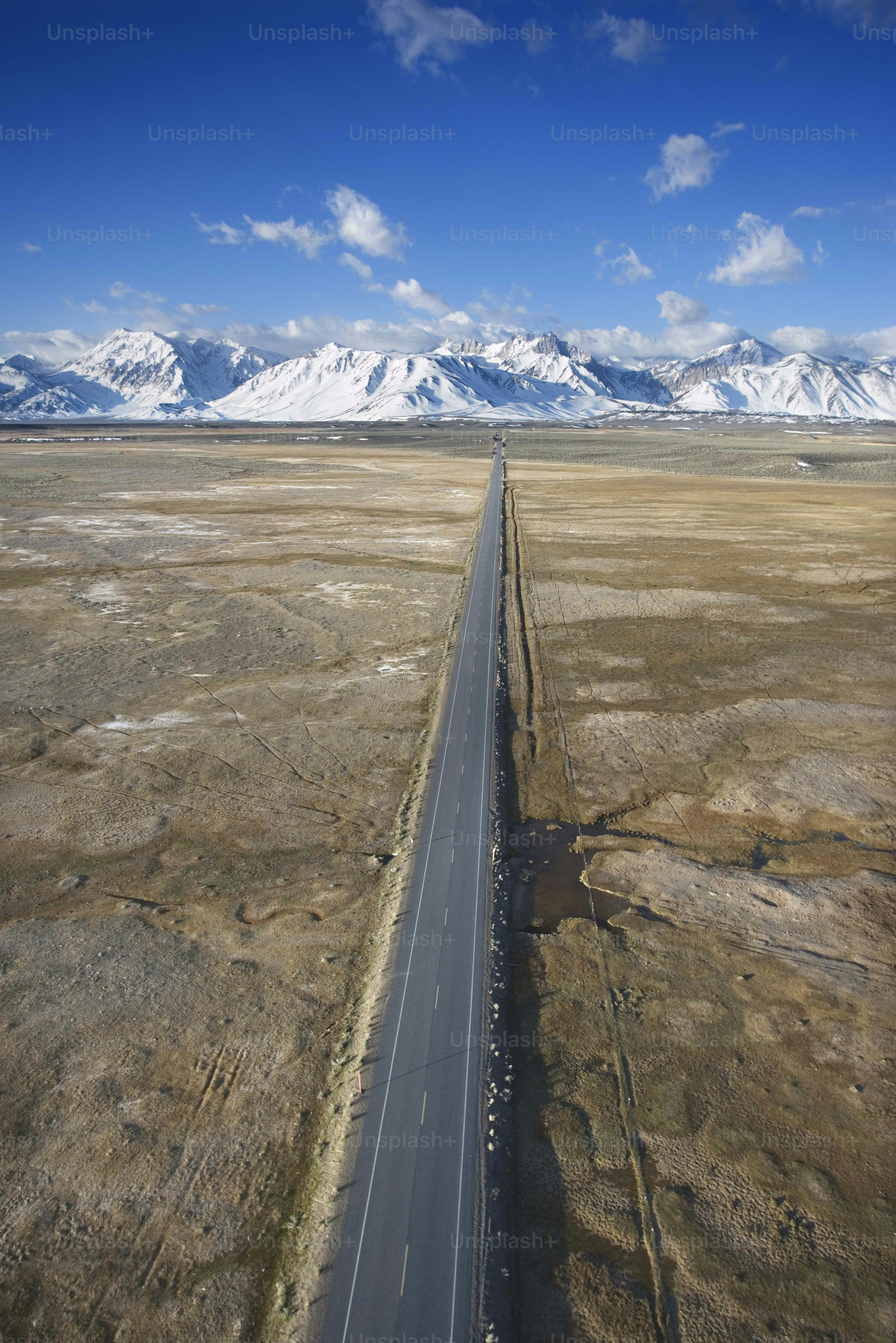 an aerial view of a road in the middle of nowhere