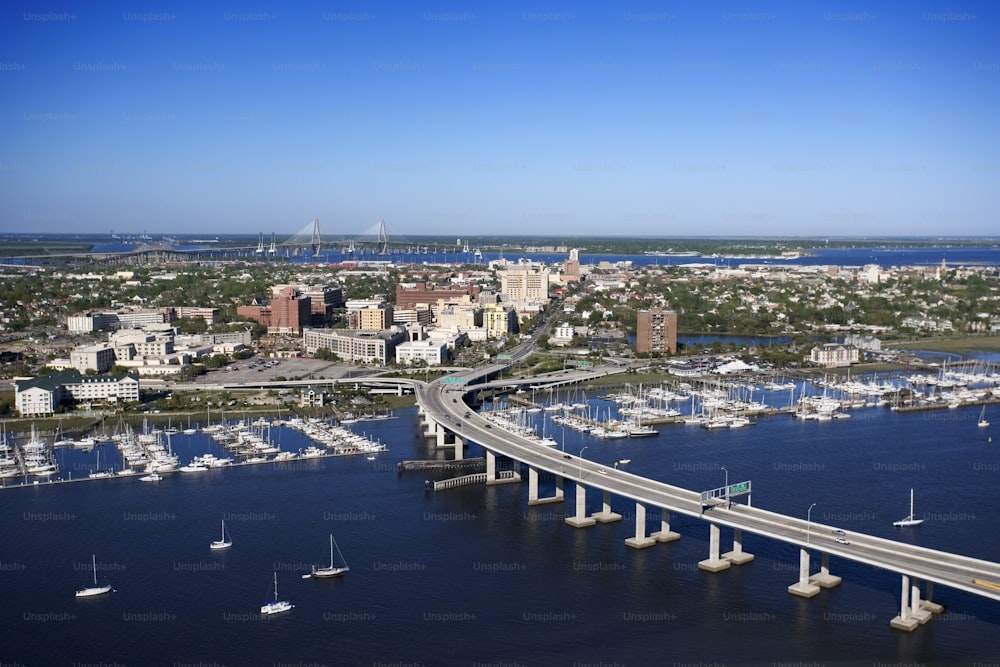 a bridge over a body of water with a city in the background