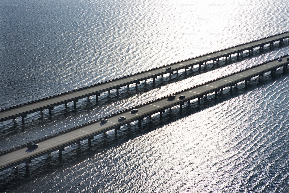 an aerial view of a bridge over a body of water