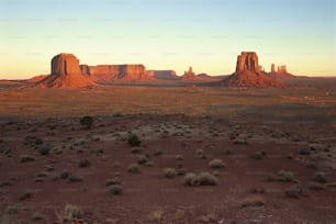 a desert landscape with mountains in the background