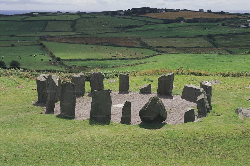 a group of rocks sitting in the middle of a field