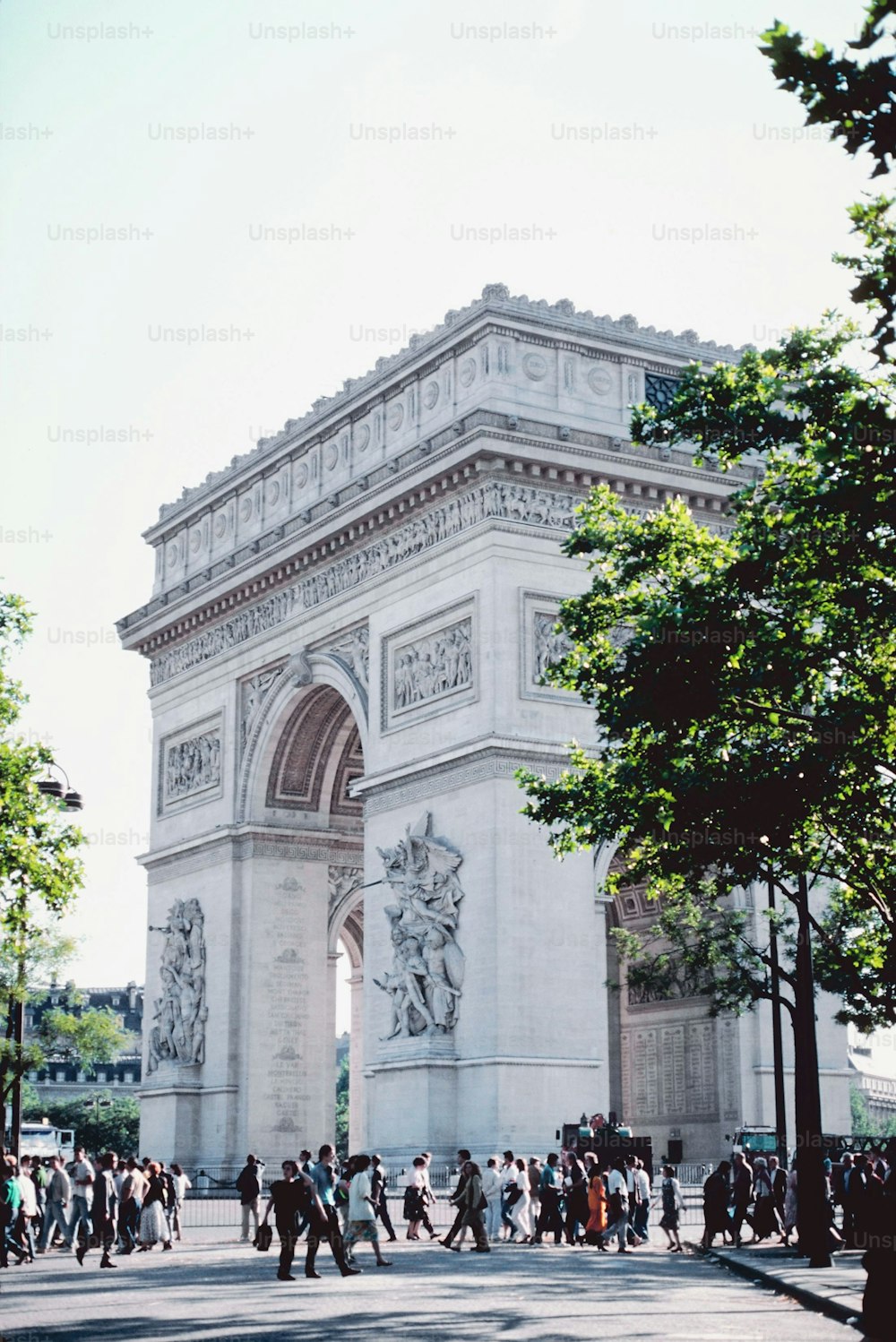 a group of people standing in front of the arc de trioe