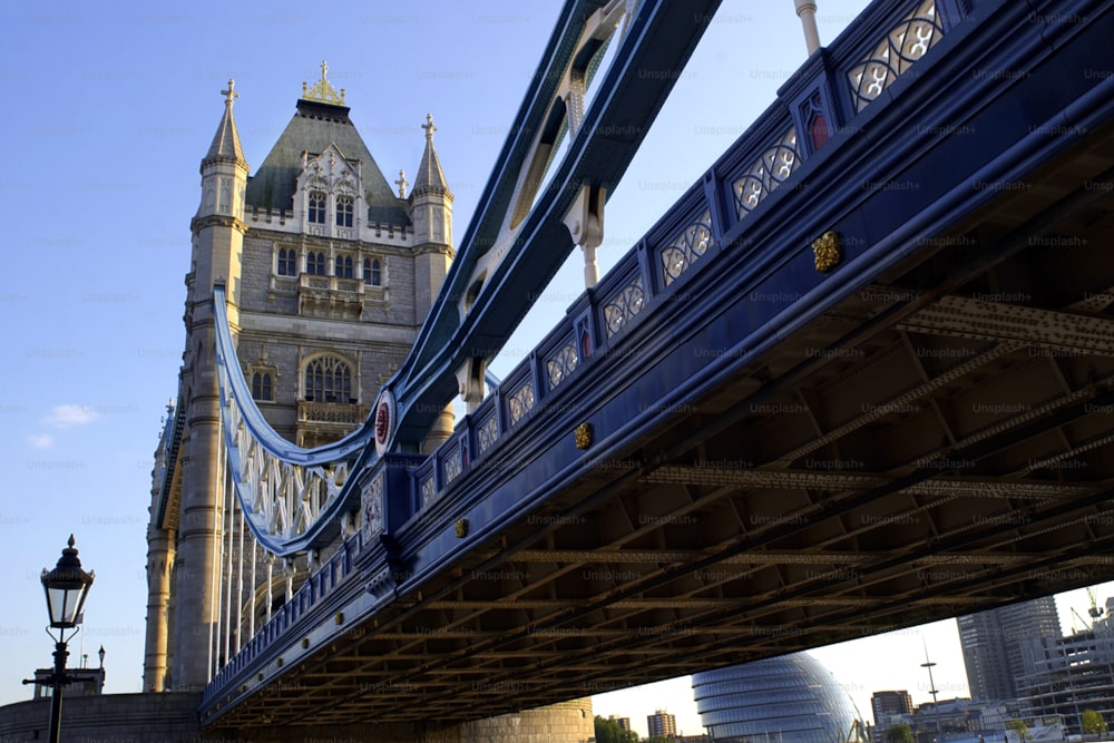 a bridge with a clock tower in the background