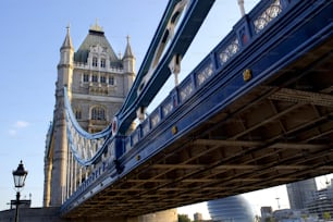 a bridge with a clock tower in the background