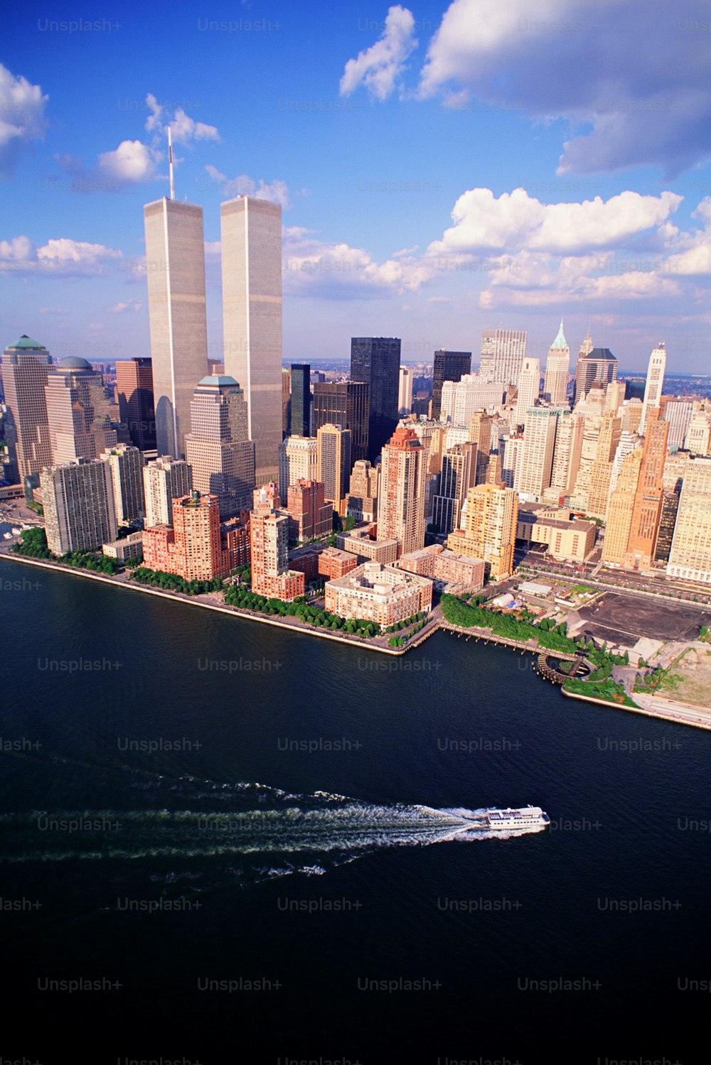 a boat is in the water in front of a large city