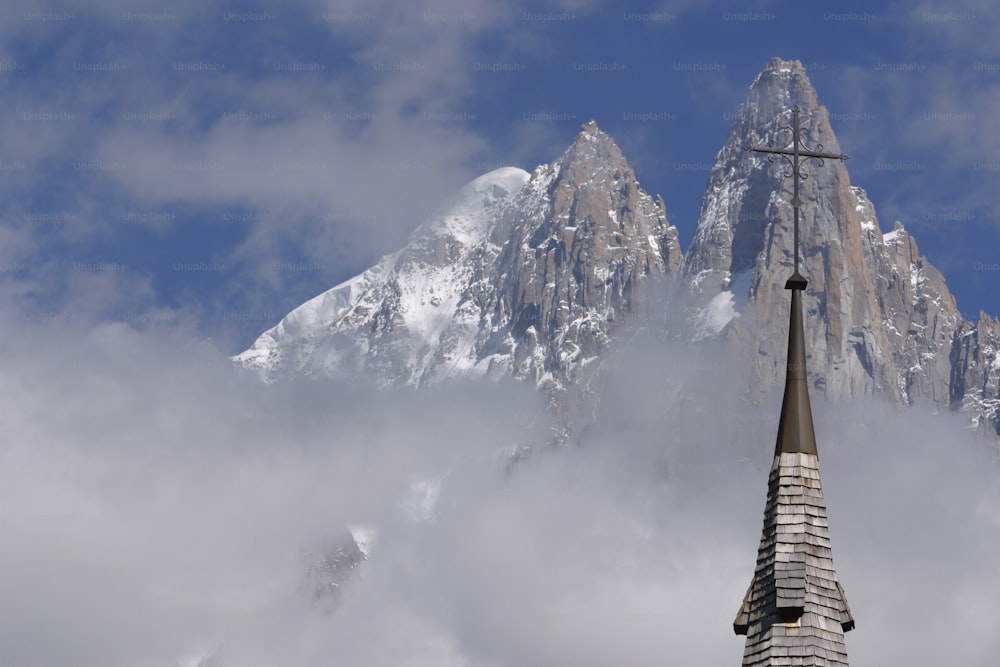 a church steeple with a mountain in the background