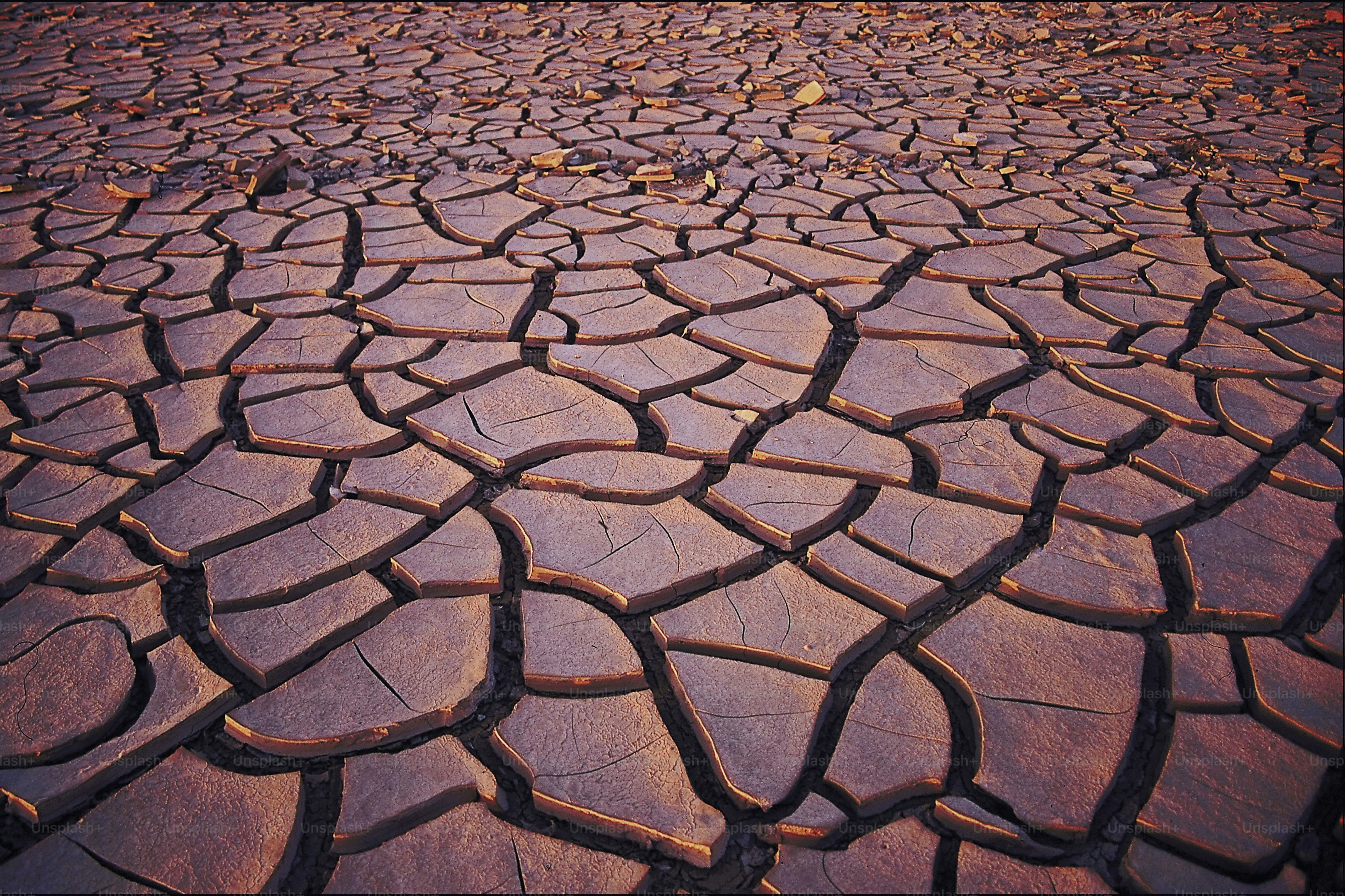 a large patch of dirt with a sky in the background