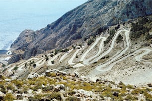 a winding mountain road with a view of the ocean