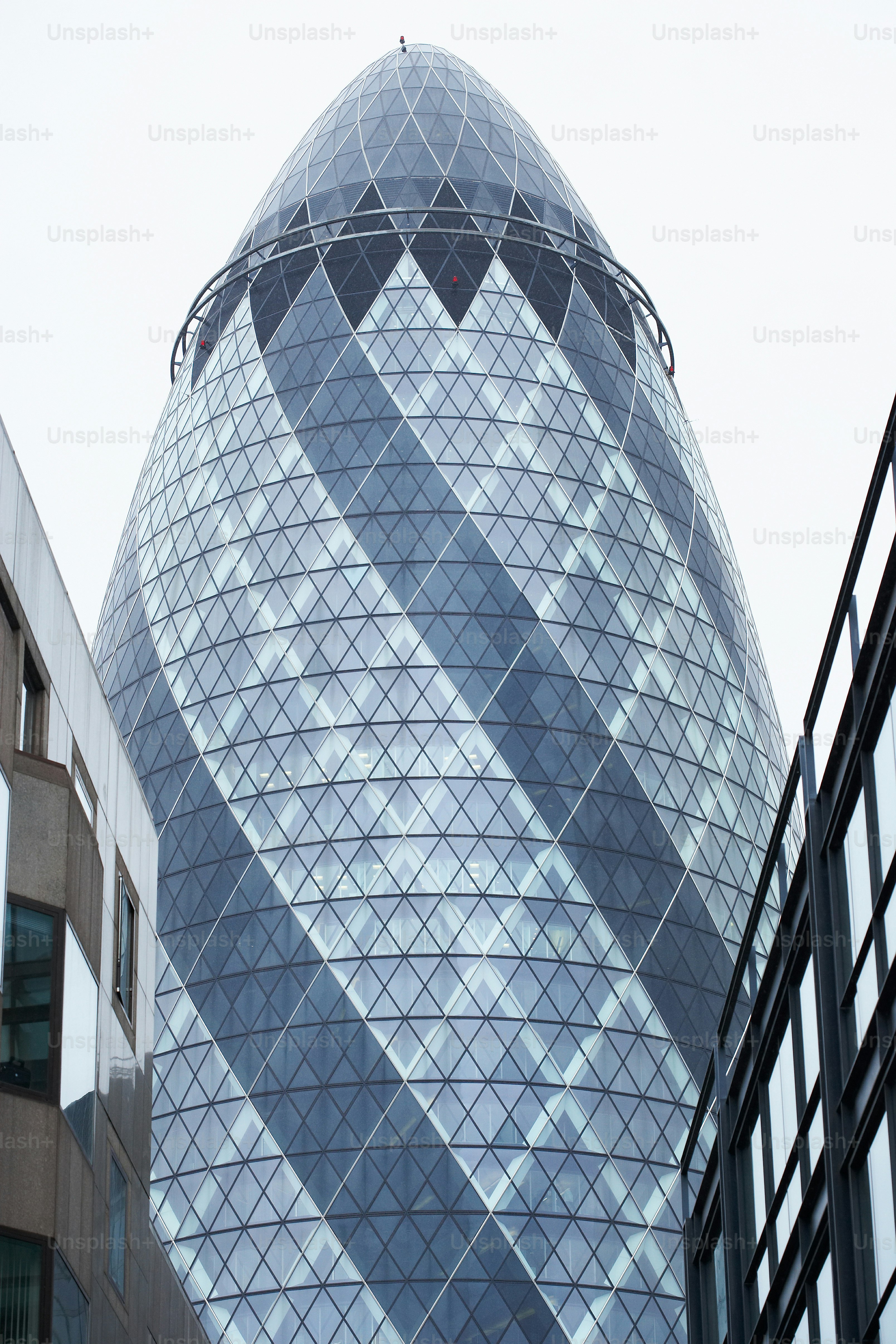 Picture of A very tall glass building next to a tall building photo – Design Image ...