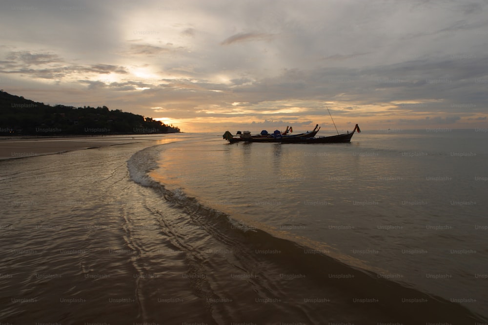 a group of people riding on top of a boat in the ocean