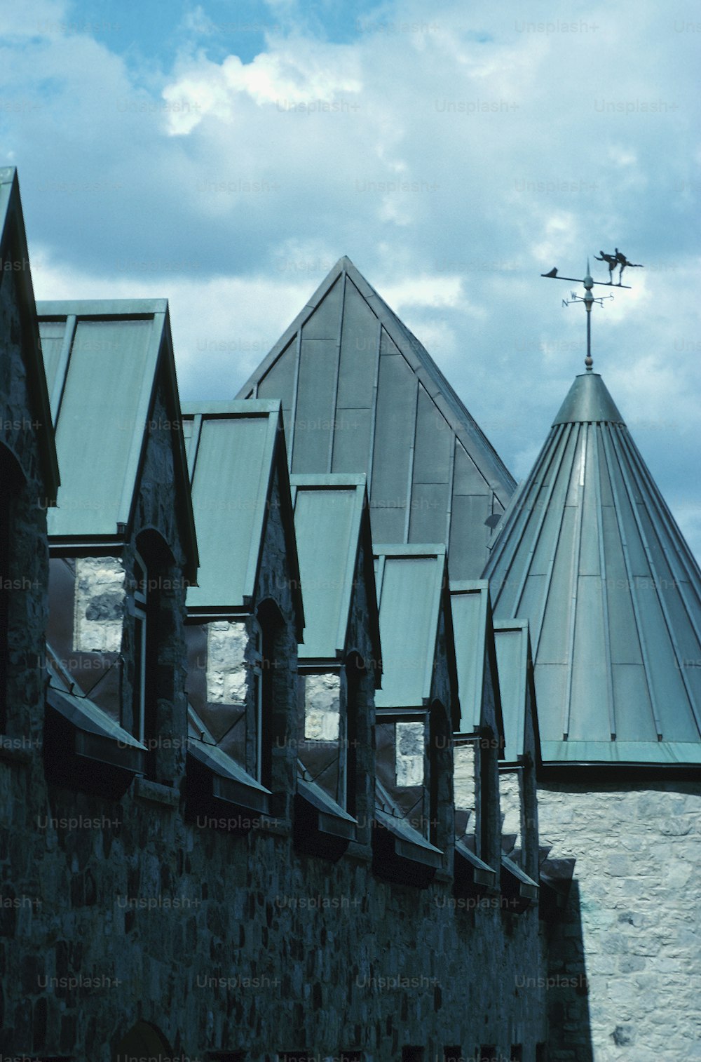 a view of a building with a weather vane on top of it