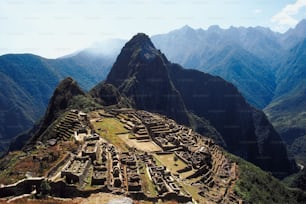 a view of a mountain range with a very large structure in the foreground