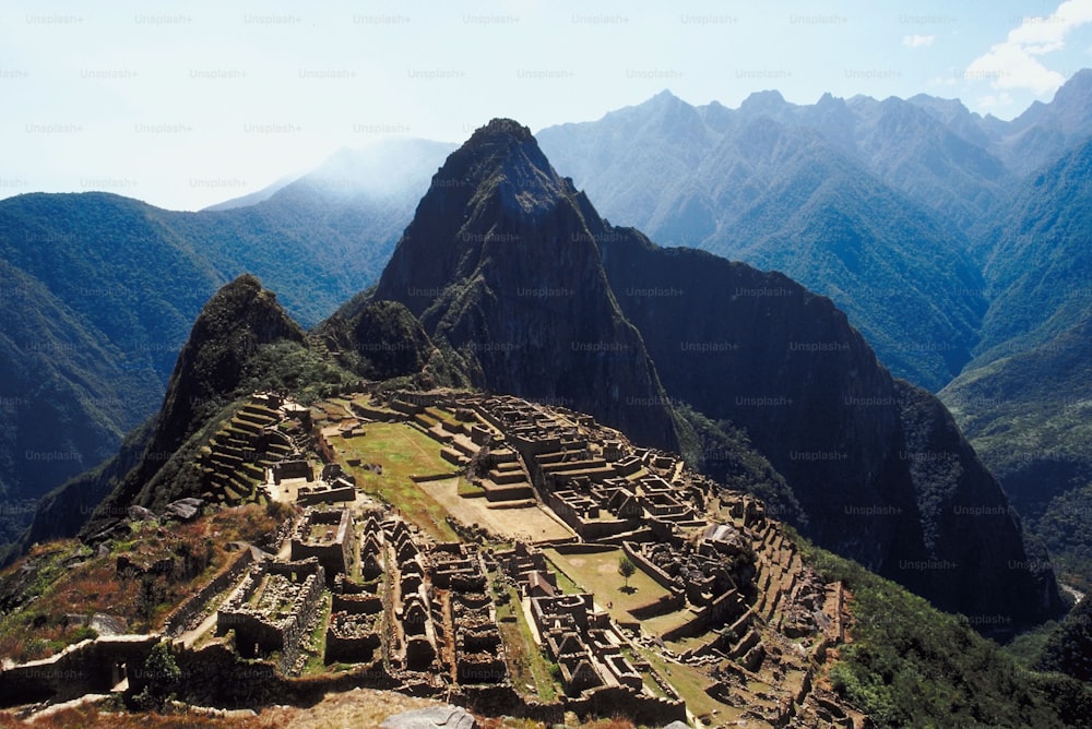 a view of a mountain range with a very large structure in the foreground