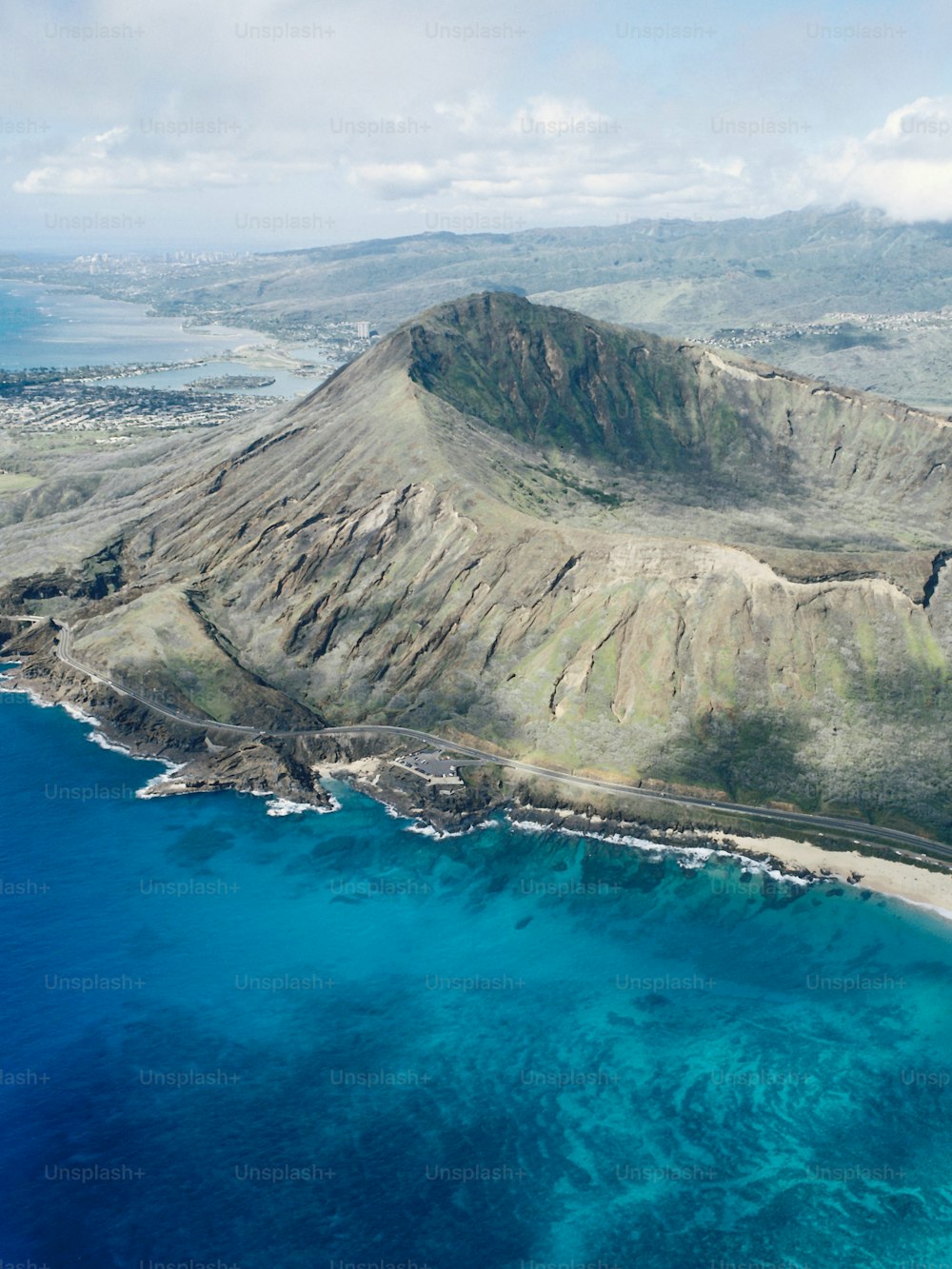 an aerial view of a mountain and a body of water