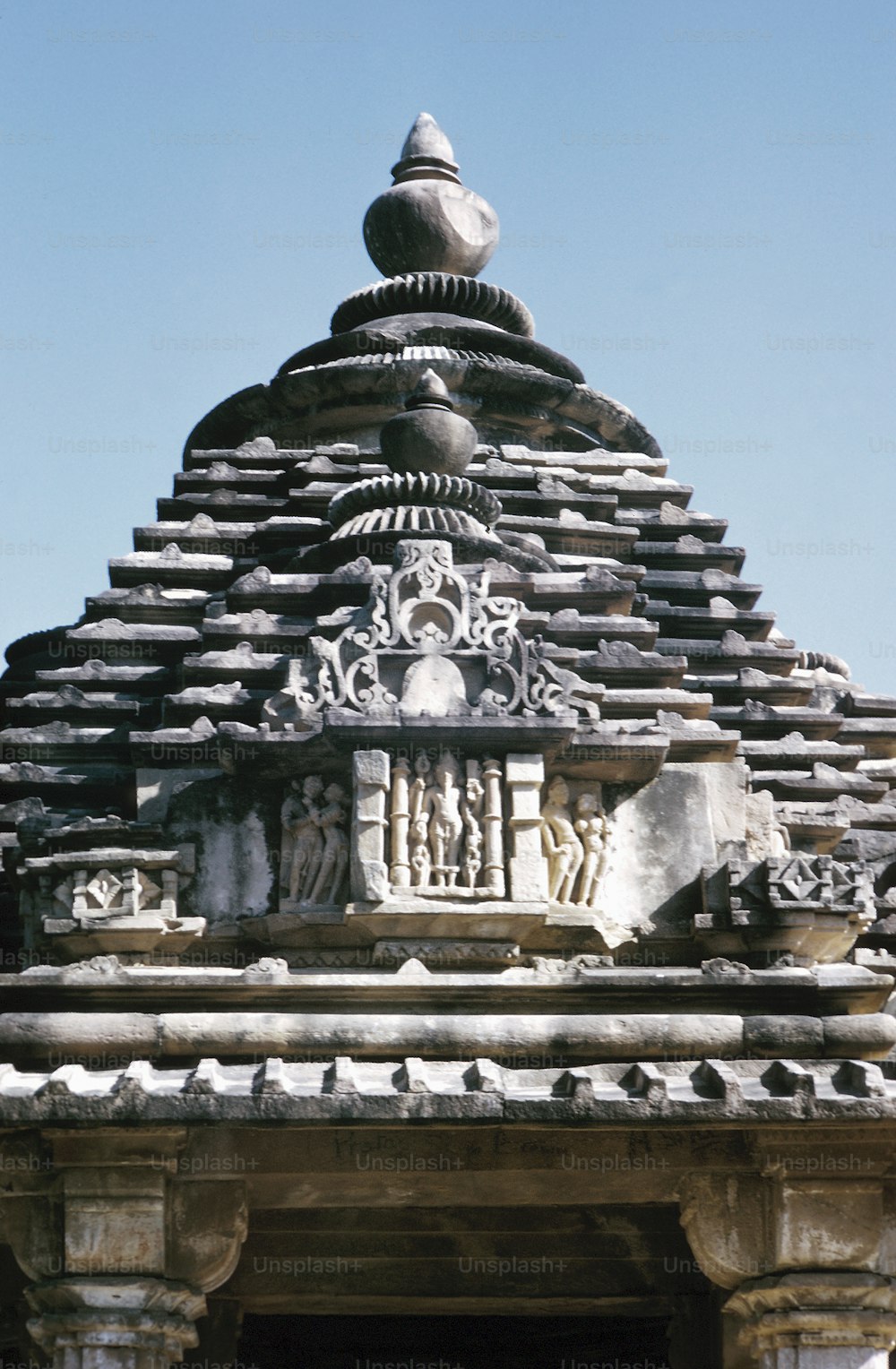 a large stone structure with sculptures on top of it