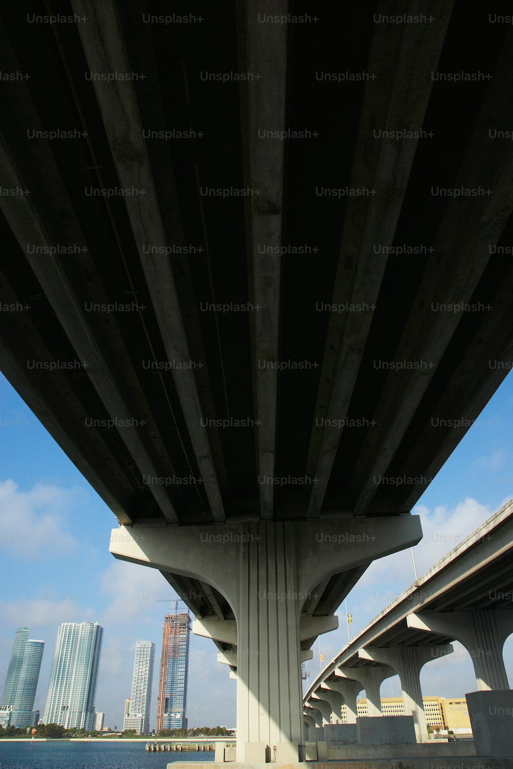 the underside of a bridge over a body of water