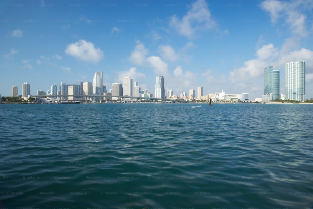 a body of water with a city in the background