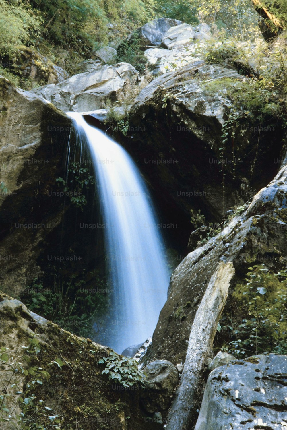 a small waterfall in the middle of a rocky area