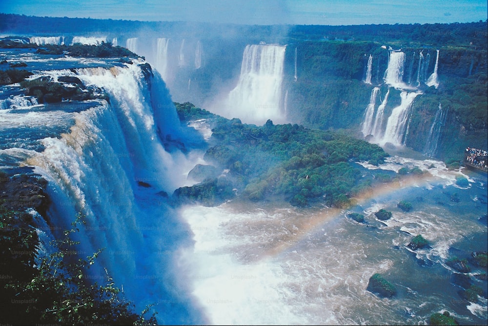 a waterfall with a rainbow in the middle of it