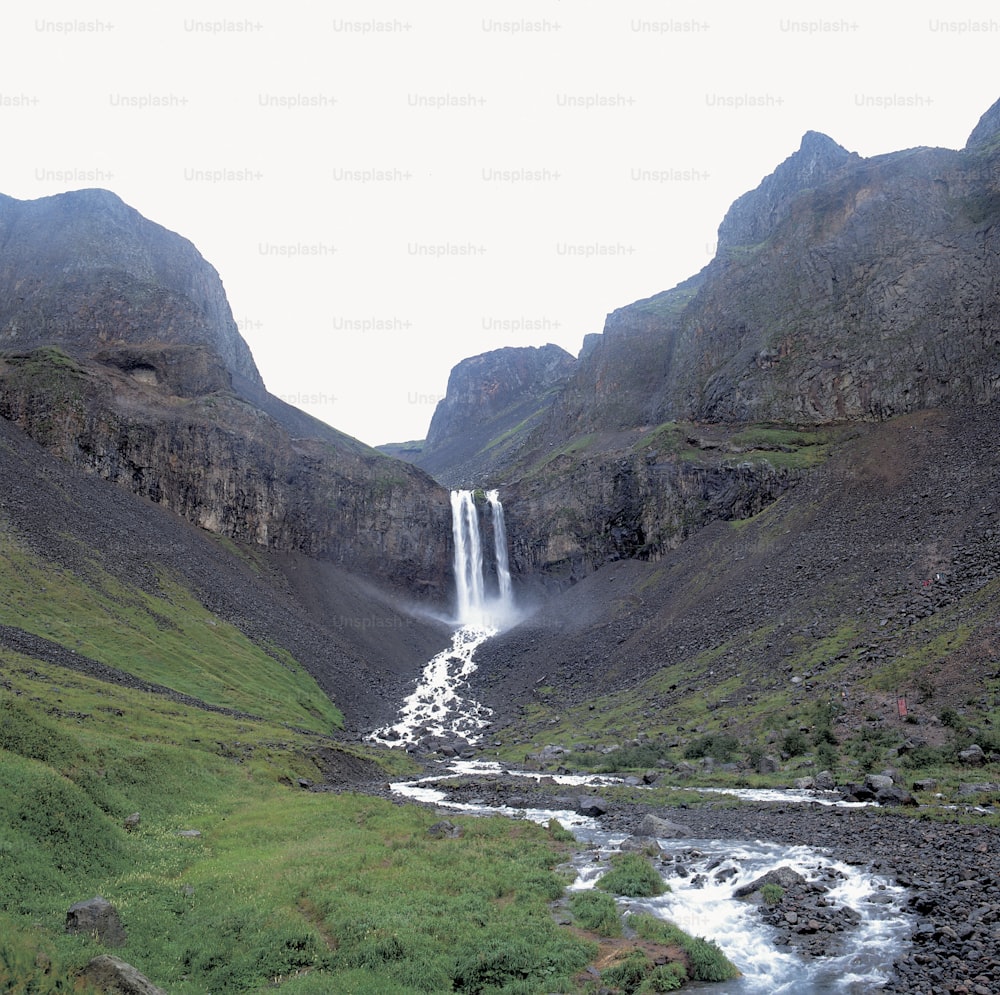 a waterfall in the middle of a valley