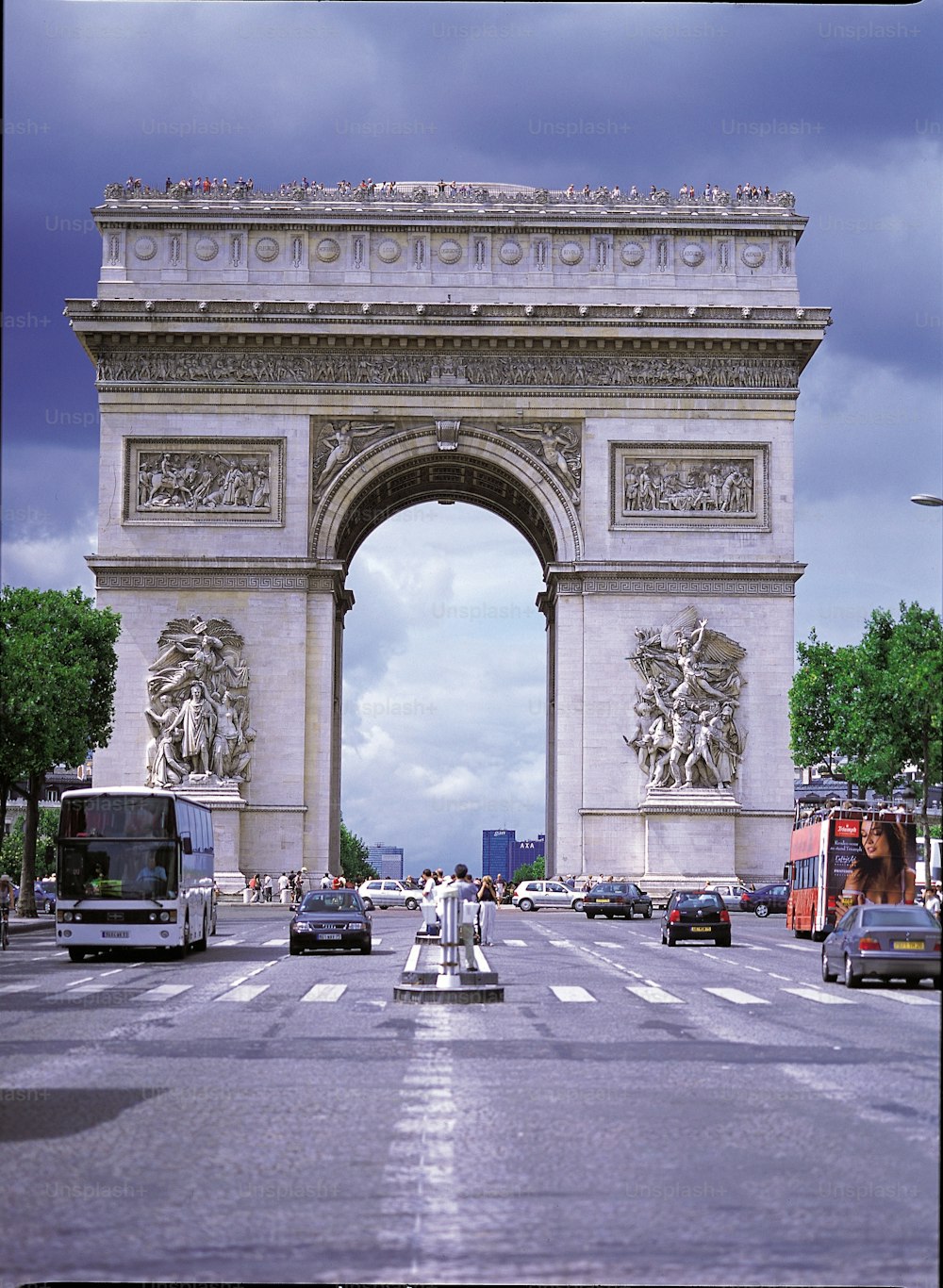 a busy city street with cars and buses