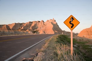 a yellow road sign sitting on the side of a road