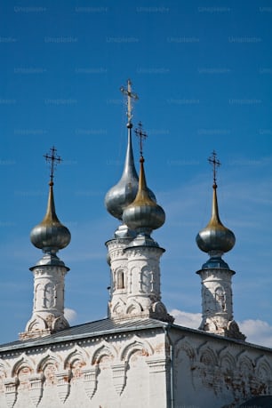 a church with three steeples and a cross on top