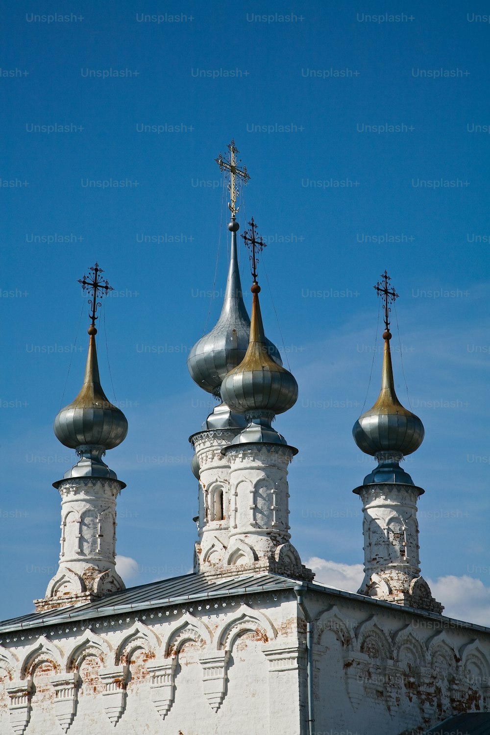 a church with three steeples and a cross on top