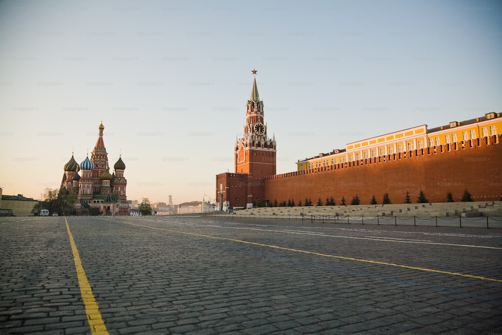 a large brick building with a clock tower in the background