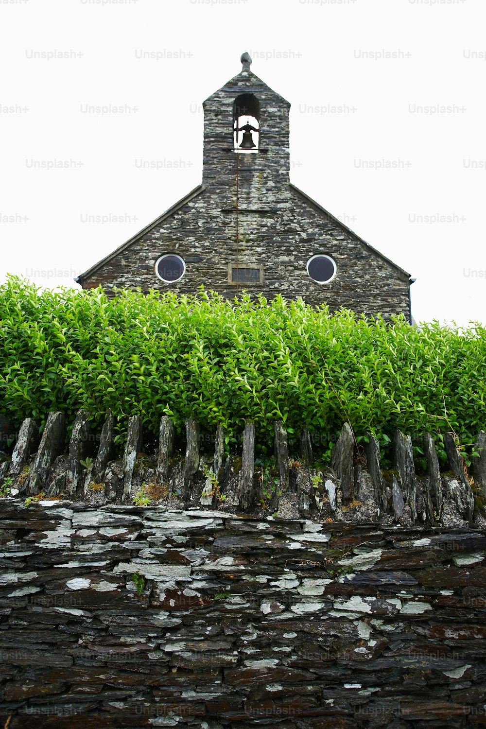a stone building with a clock on the top of it
