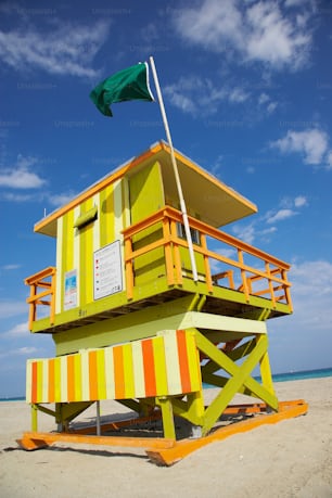 a lifeguard tower with a flag on top of it