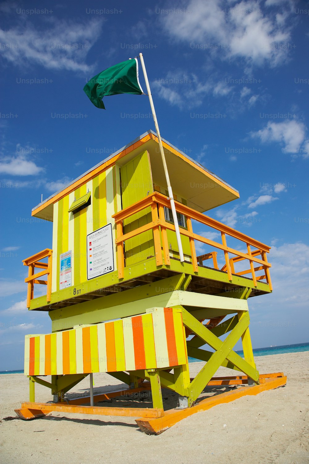 a lifeguard tower with a flag on top of it