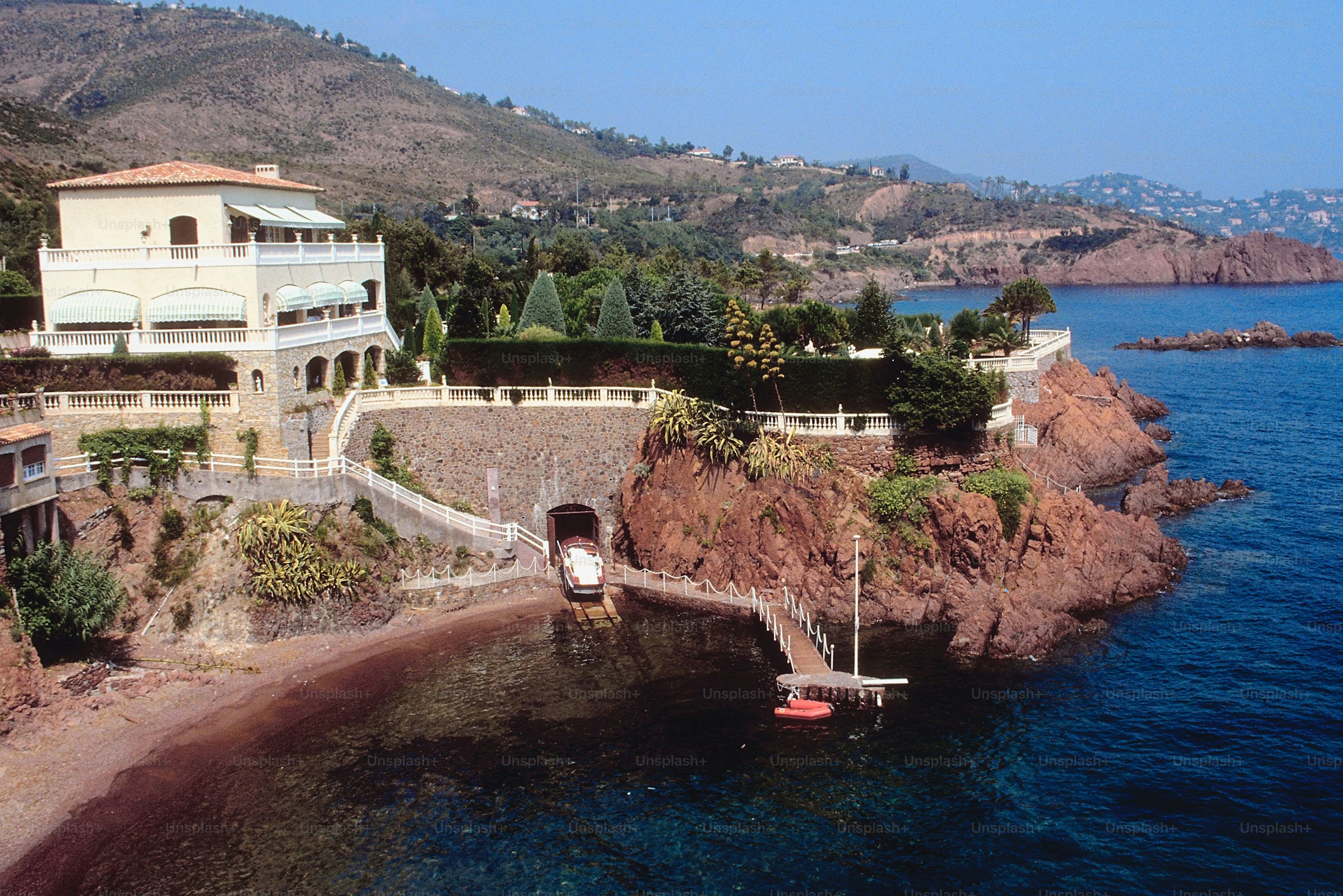 a house on a cliff overlooking a body of water