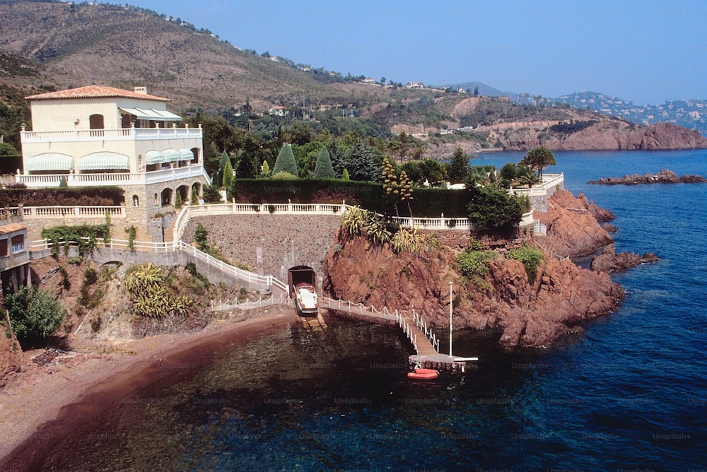 a house on a cliff overlooking a body of water