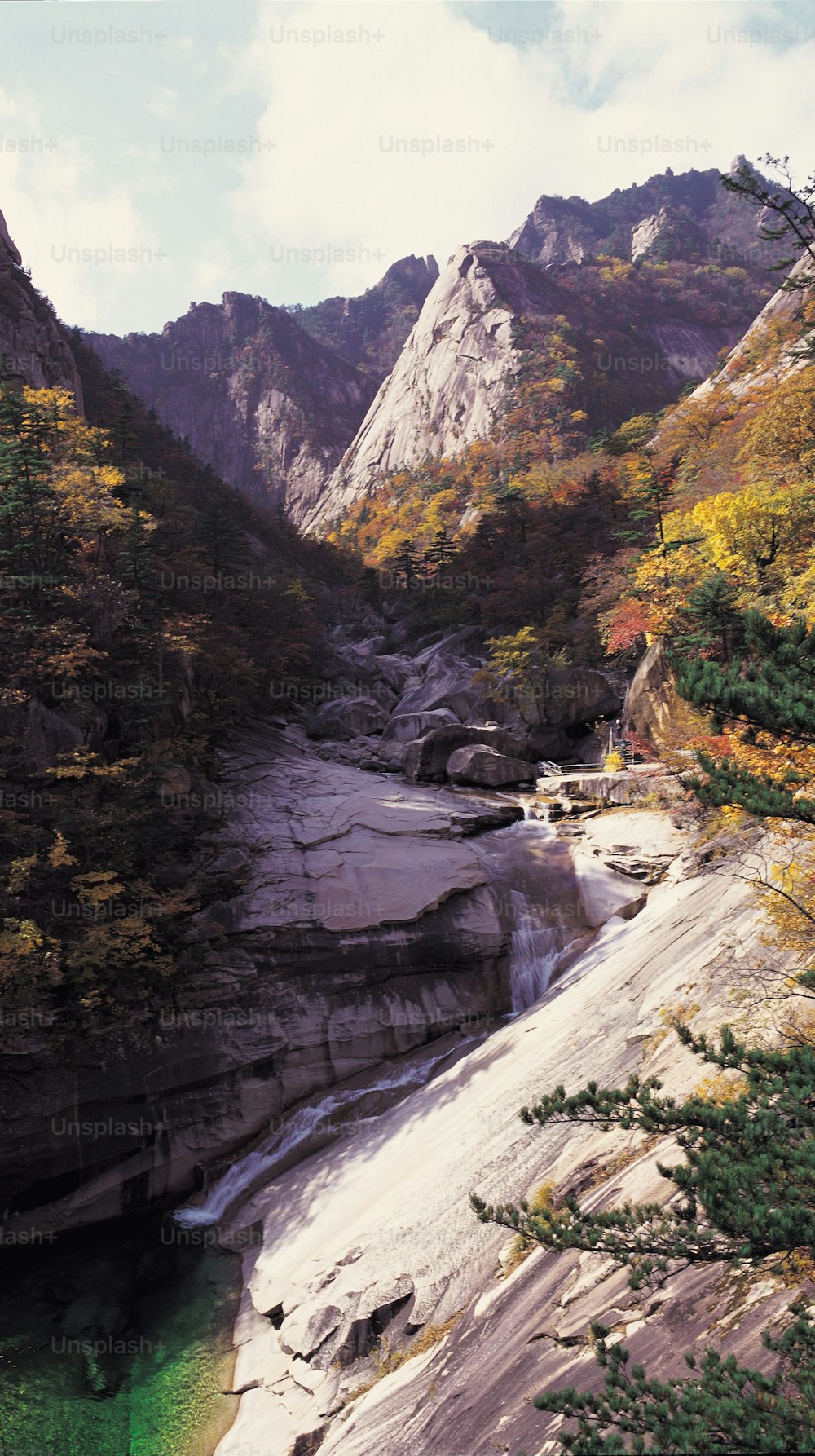 a river running through a valley surrounded by mountains