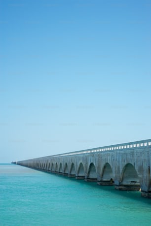 a long concrete bridge over a body of water