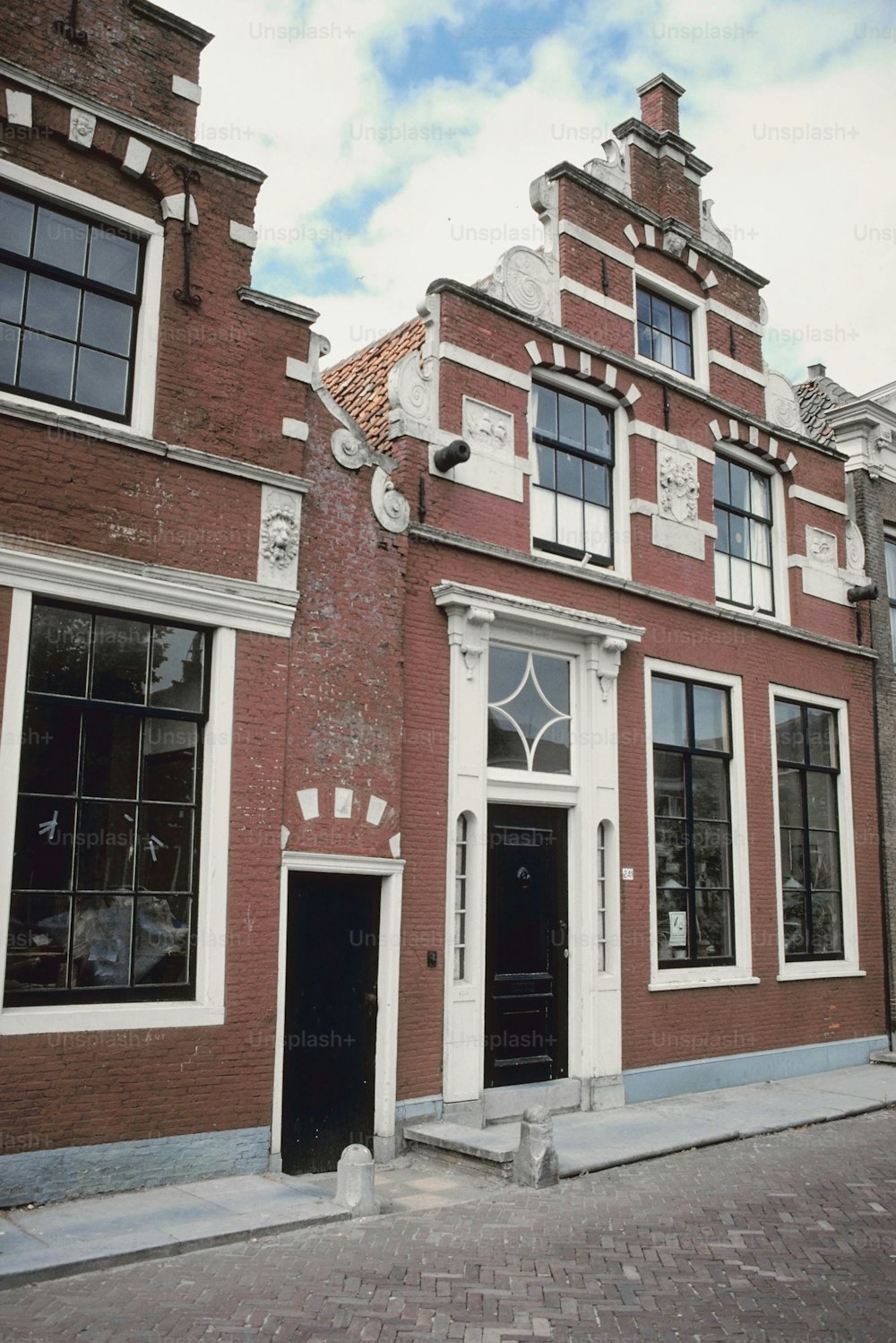 a red brick building with two black doors