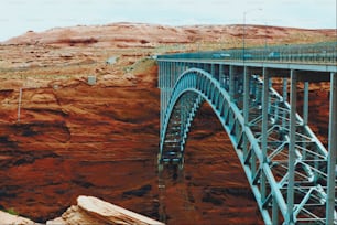 a bridge over a canyon with a mountain in the background