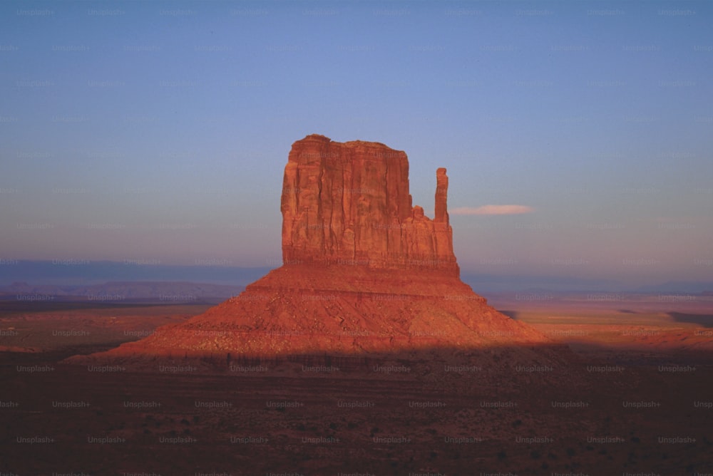 a large rock formation in the middle of a desert