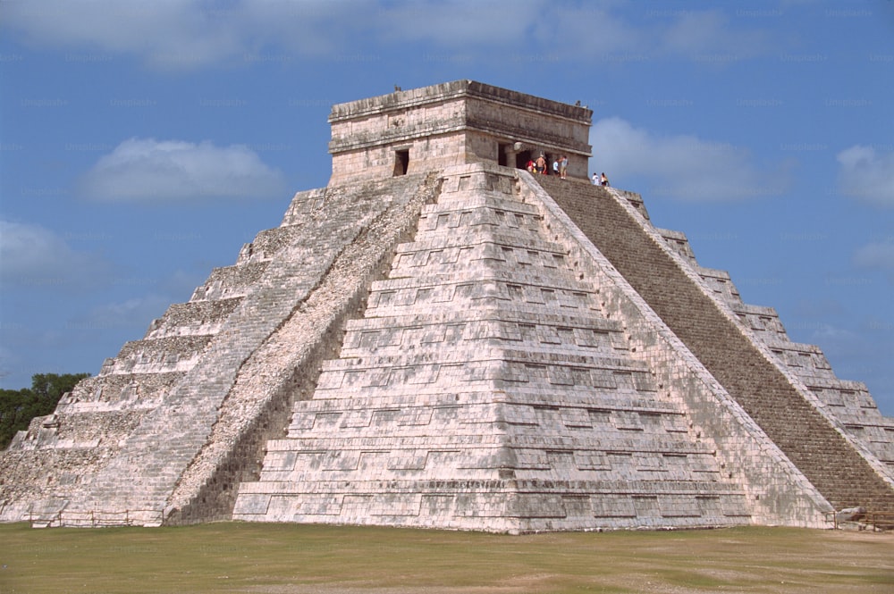 a group of people standing on top of a pyramid