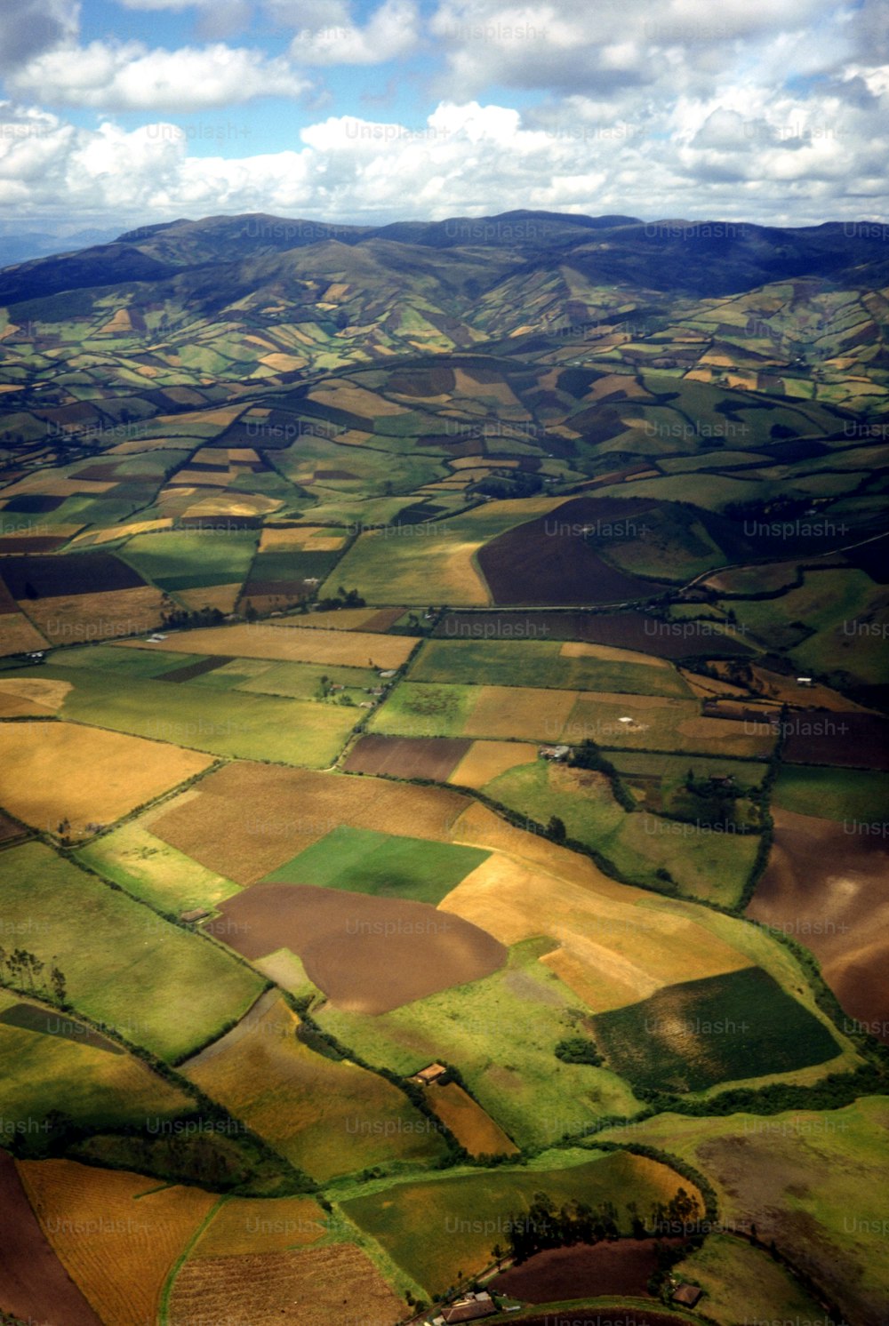 an aerial view of a green and yellow field