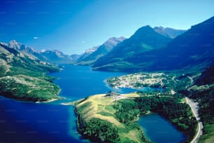 an aerial view of a lake surrounded by mountains