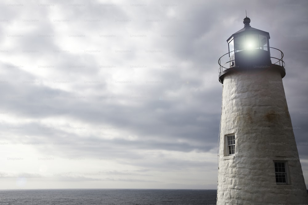 a light house sitting on top of a cliff next to the ocean