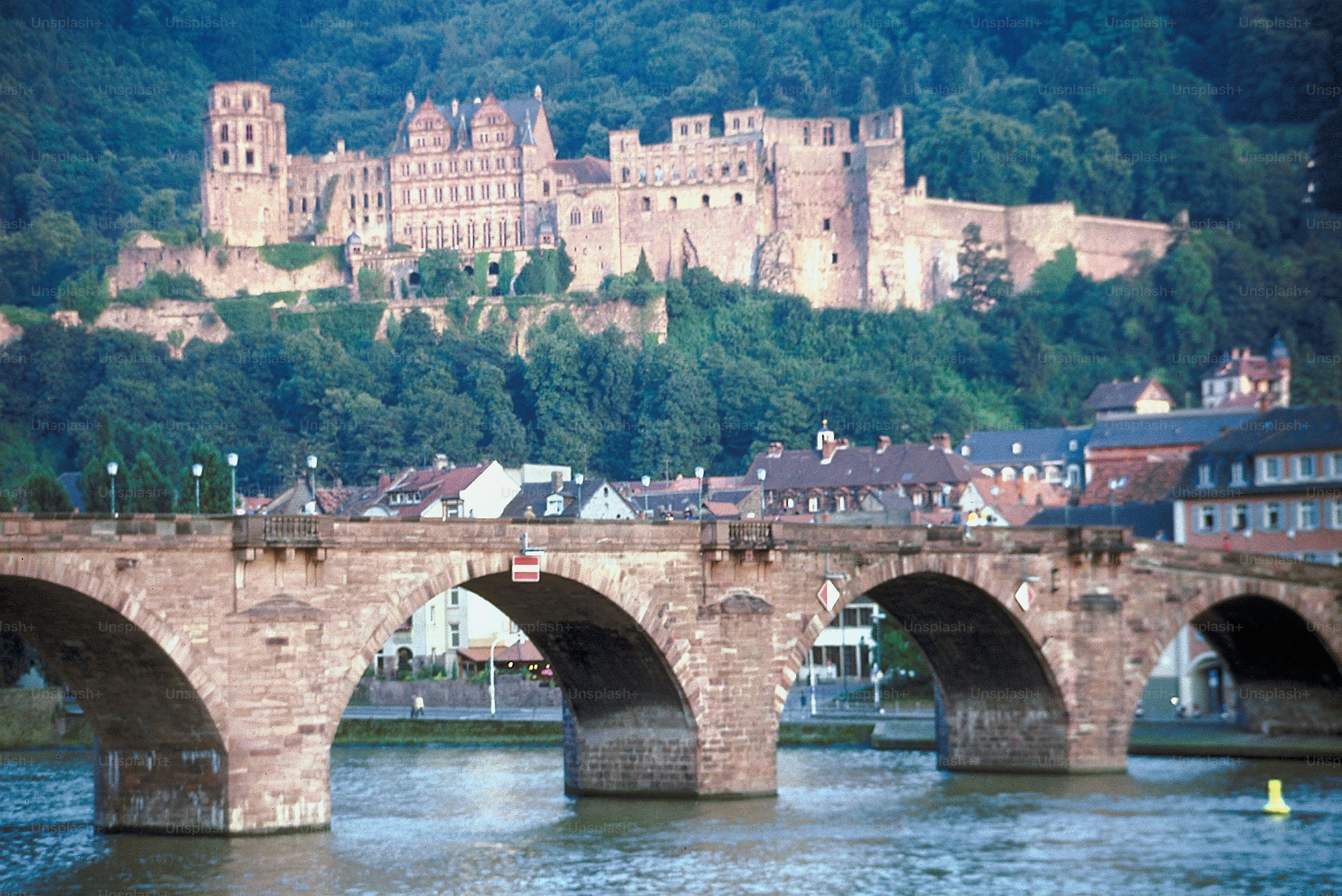 eine Brücke über einen Fluss mit einer Burg im Hintergrund